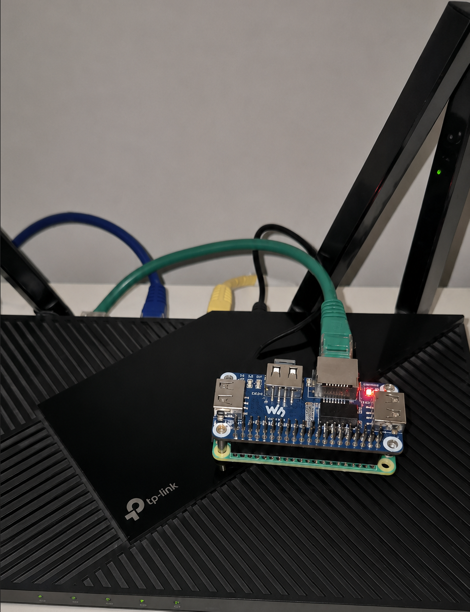 Raspberry Pi Zero 2W with a Waveshare Ethernet and USB HAT installed on a TP-Link router